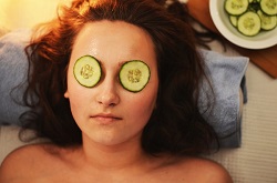 Woman with cucumbers over eyes. Home remedies that do and don't work