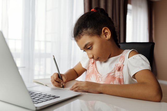 school-aged girl, mixed race, doing homework