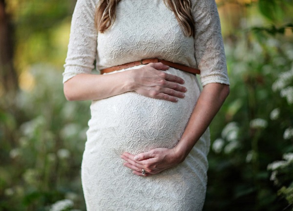 Pregnant woman holding belly