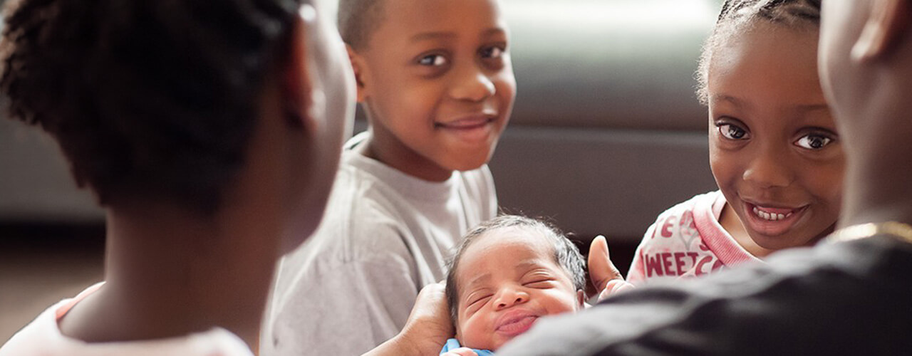 kids welcoming their baby sibling