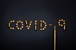 COVID-19 spelled out in copper text with syringe, artistic display 