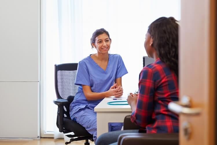 a nurse talking to a patient